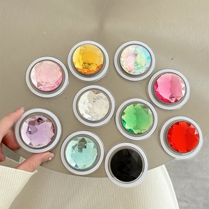 Macro view of ten colors of sparkling gemstone pop-socket phone stands for easy grip