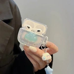 Close-up of clear iridescent AirPods case with rhinestone clouds and star pendant charm
