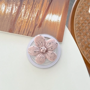 Detailed close-up of a pink flower-shaped phone socket with artistic black spots