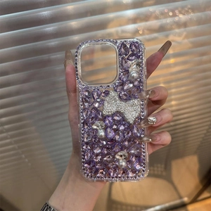 Macro detail of luxury purple rhinestone phone case with bow and pearl decorations