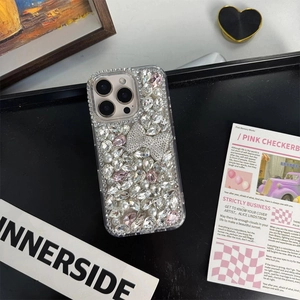 Macro detail of luxury iPhone case with pink crystals and shimmering rhinestone bow