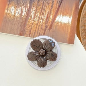 Detailed top view of a brown flower-shaped phone grip with a speckled texture