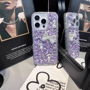 Detail of luxury iPhone case with purple crystals, white pearls and a glittery bow