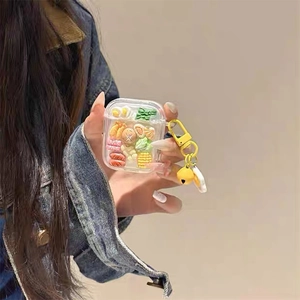 Cartoon food theme AirPods case with resin charms including corn and fried egg