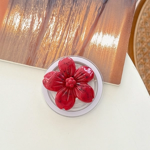 Detailed top view of a red flower popsocket with black spots and transparent base
