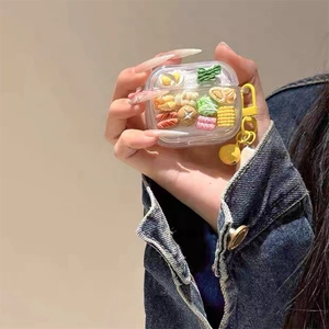 Detail of clear AirPods case featuring 3D mini food charms with a yellow metal hook