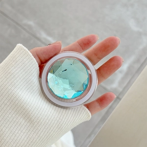Close-up of a stylish rhinestone phone socket featuring a large light blue faceted crystal