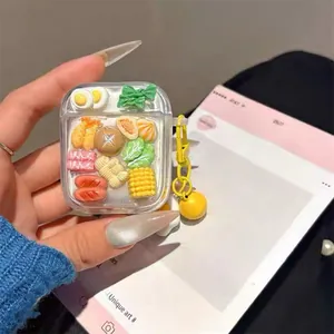 Detail of clear AirPods case featuring miniature 3D food models like tempura and sausage