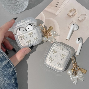 Glittery transparent case for AirPods with pearl bow charm and rhinestone details