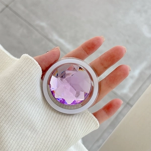 Detailed view of a purple rhinestone phone grip featuring faceted crystal on a ring holder