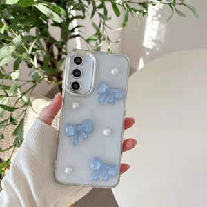 Detail of glitter clear phone case with 3D blue bows and pearls for Samsung S25 Ultra