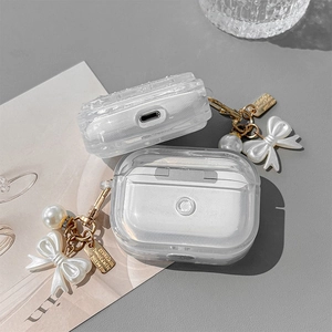 Glittery transparent AirPods Pro case with elegant white bow and pearl charm attachment