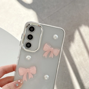 Detail view of 3D pink bows and pearls on transparent Samsung phone case backplate