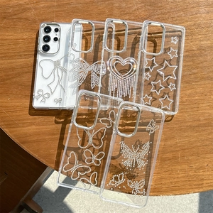 Transparent Samsung Galaxy case with rhinestone bow, heart and star patterns on wood