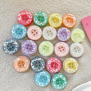Detail of colorful resin phone grips with glitter and heart sequins for DIY accessories