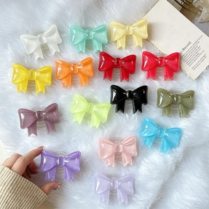 Colorful 3D bowknot phone socket stands set on white fur background for mobile support