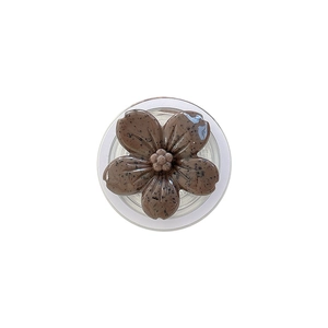 Brown flower pop socket phone grip with dark speckles on a clean white background
