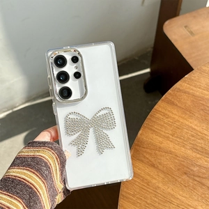 Close-up of a sparkling silver rhinestone bow design on a luxury Samsung S24 case