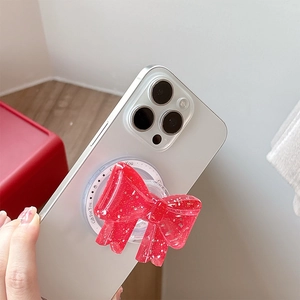 Detail der roten Glitzer-Schleife Handyhalterung mit magnetischer MagSafe-Basis und Sternen