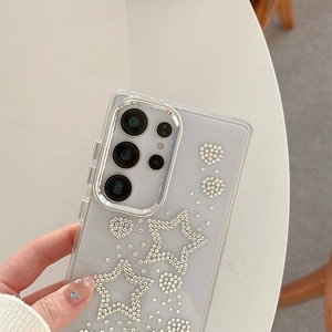 Close-up of clear phone case with silver rhinestone star patterns and camera protection