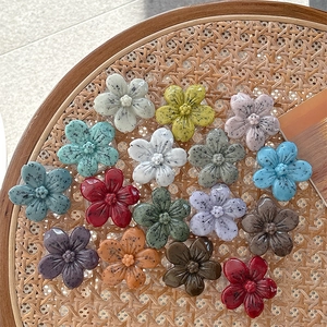 Detailed view of 15 colorful 3D resin flower phone grips with stone texture on a tray