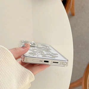 Detailed close-up of clear phone case featuring silver rhinestone butterfly pattern and S-Pen slot