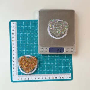 Macro shot showing heart-shaped phone grip weight and size measurement details
