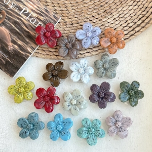 Set of colorful resin flower phone grips with ink splatter texture on diverse backgrounds