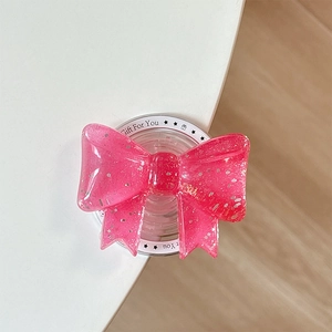 Detail-Makroansicht einer glitzernden rosa Schleife Magnethalterung aus Harz für Handys