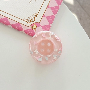Macro shot of cute light pink translucent resin phone socket button with cloud patterns