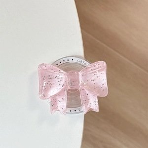 Nahaufnahme der rosa Glitzer-Bogen Magsafe-Halterung mit Gift For You Textur