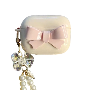 Creamy white AirPods 4 case featuring a pink bow and elegant pearl chain attachment
