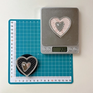Detailed view of rhinestone heart phone sockets with mirrors on measuring scale