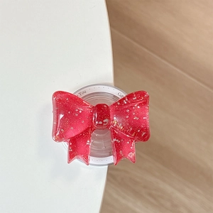 Makro-Detail des roten Glitzer-Schleifen-Handyhalters mit MagSafe-Magnetbasis