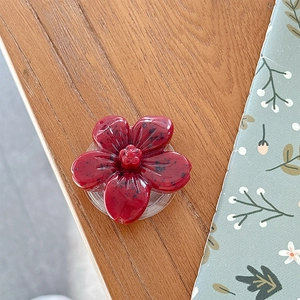 Macro detail of dark red 3D flower phone socket with unique fruit-like resin texture