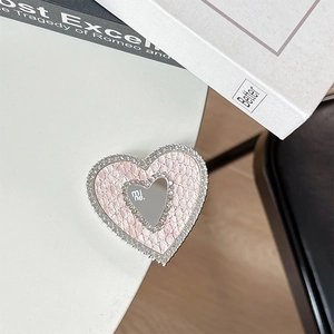Close-up of pink faux-leather heart phone grip with mirror and rhinestone borders