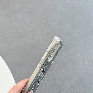 Detailed side view of clear phone case featuring precise button cutouts and bow accent