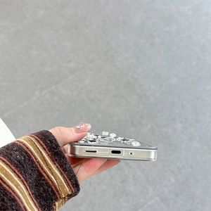 Close-up of precise charging port and speaker cutouts on the rhinestone bow case