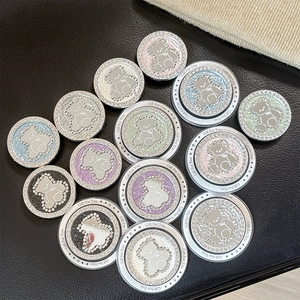 Detailed view of rhinestone-encrusted bear phone socket grips in various glitter colors