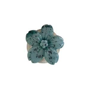 Blue-green floral phone grip with terrazzo texture and five-petal 3D blossom design