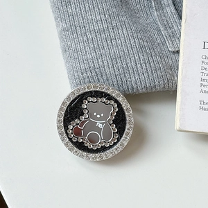 Detail of magnetic phone grip with rhinestone circle and cute bear motif for desktop