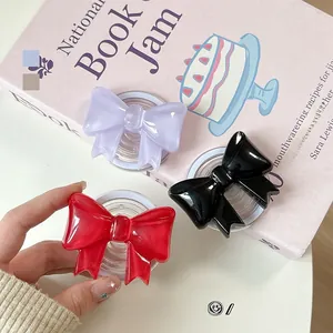 Detailed view of glossy 3D bow magnetic phone sockets in red, purple and black colors