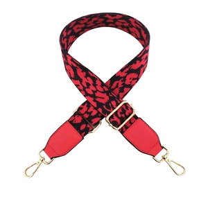 Adjustable red leopard print shoulder strap with leather ends and gold metal clips