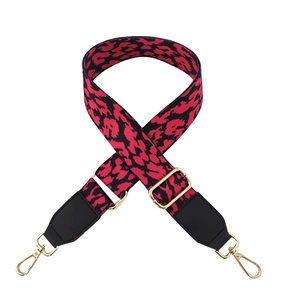 Detail of adjustable leopard print bag strap with golden metal swivel lobster clasps
