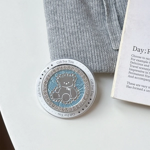 Close-up of a blue rhinestone bear phone grip and makeup mirror with Gift For You text