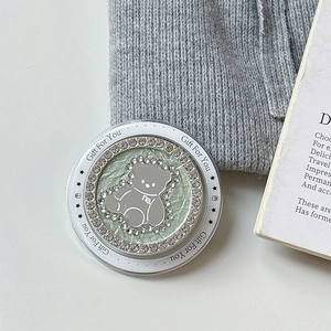 Close-up of mint green magnetic phone socket with rhinestone bear and Gift For You text