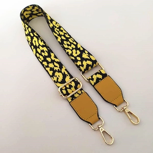 Adjustable leopard print bag strap with gold hardware and yellow faux leather detail