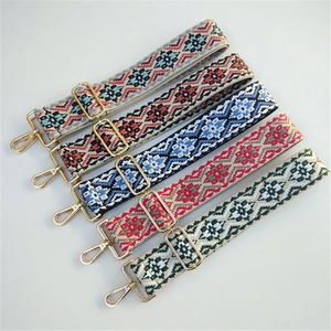 Close-up of five colorful ethnic embroidered bag straps with golden metal buckles