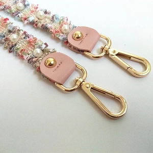 Elegant multi-colored tweed shoulder strap with pearl accents and golden metal clasps