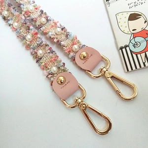 Handwoven pearl bag strap with multi-color threads and shiny gold metal lobster clasps